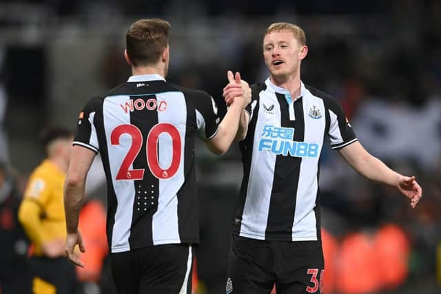 Newcastle player Sean Longstaff congratulates goal scorer Chris Wood after the Premier League match between Newcastle United and Wolverhampton Wanderers at St. James Park on April 08, 2022 in Newcastle upon Tyne, England. (Photo by Stu Forster/Getty Images)