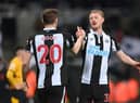 Newcastle player Sean Longstaff congratulates goal scorer Chris Wood after the Premier League match between Newcastle United and Wolverhampton Wanderers at St. James Park on April 08, 2022 in Newcastle upon Tyne, England. (Photo by Stu Forster/Getty Images)