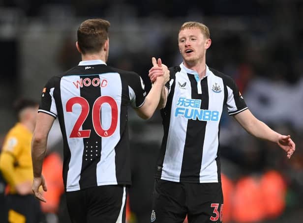 Newcastle player Sean Longstaff congratulates goal scorer Chris Wood after the Premier League match between Newcastle United and Wolverhampton Wanderers at St. James Park on April 08, 2022 in Newcastle upon Tyne, England. (Photo by Stu Forster/Getty Images)