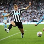 Phil Foden of Manchester City attempts to cross the ball past Emil Krafth of Newcastle United during the Premier League match between Newcastle United and Manchester City at St. James Park on August 21, 2022 in Newcastle upon Tyne, England. (Photo by Clive Brunskill/Getty Images)