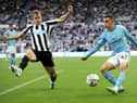 Phil Foden of Manchester City attempts to cross the ball past Emil Krafth of Newcastle United during the Premier League match between Newcastle United and Manchester City at St. James Park on August 21, 2022 in Newcastle upon Tyne, England. (Photo by Clive Brunskill/Getty Images)