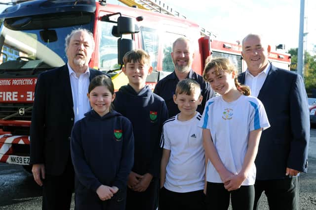 South Tyneside Council Cllr Jim Foreman and Cllr Ernest Gibson with TWFRS prevention education officer Colin Soulsby, pupils from St Oswald's CofE Primary School, Hebburn, and Bede Burn Primary School, Jarrow.
