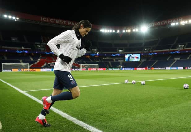 PARIS, FRANCE - MARCH 11: (FREE FOR EDITORIAL USE) In this handout image provided by UEFA, Edinson Cavani of Paris Saint-Germain runs out to warm up prior to the UEFA Champions League round of 16 second leg match between Paris Saint-Germain and Borussia Dortmund at Parc des Princes on March 11, 2020 in Paris, France. The match is played behind closed doors as a precaution against the spread of COVID-19 (Coronavirus). (Photo by UEFA - Handout/UEFA via Getty Images)