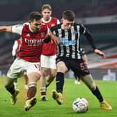 Arsenal's Cedric Soares vies with Newcastle United's Elliot Anderson.