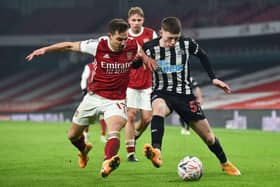 Arsenal's Cedric Soares vies with Newcastle United's Elliot Anderson.