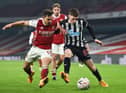 Arsenal's Cedric Soares vies with Newcastle United's Elliot Anderson.
