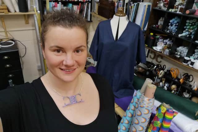 Bridalwear maker Aimee Veitch with scrubs on a mannequin
