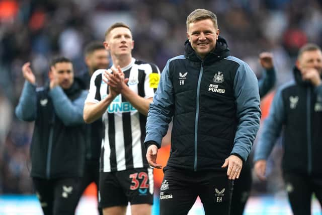 Newcastle United head coach Eddie Howe and players celebrate after the final whistle.