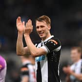 Dan Burn applauds Newcastle United fans at St James's Park.