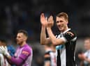 Dan Burn applauds Newcastle United fans at St James's Park.
