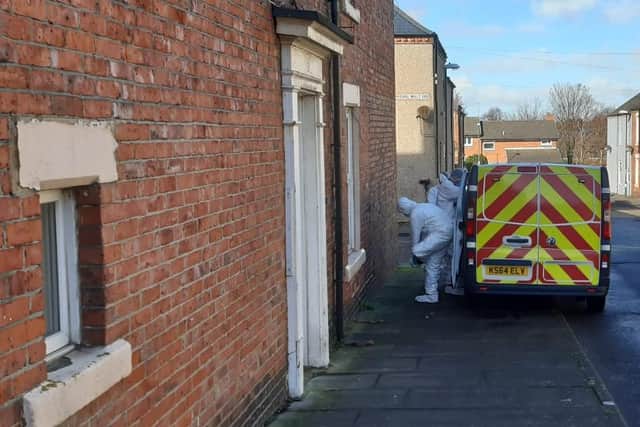 Forensics officers carry out inquiries in Marshall Wallis Road on Sunday.