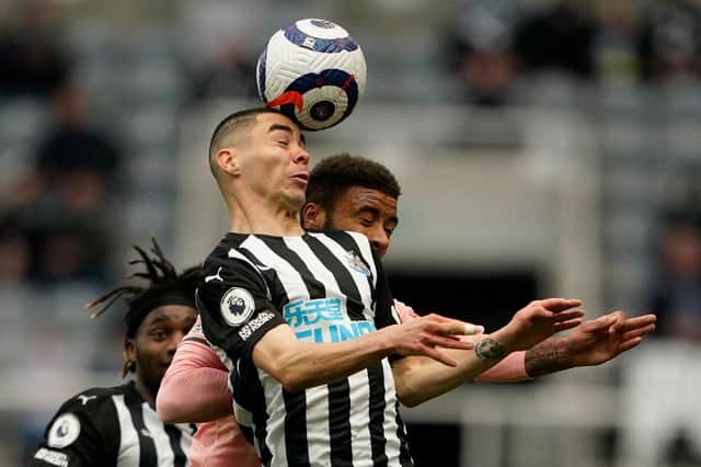 Newcastle United's Paraguayan midfielder Miguel Almiron (C) vies with Sheffield United's English defender Jayden Bogle (R) during the English Premier League football match between Newcastle United and Sheffield United at St James' Park in Newcastle-upon-Tyne, north east England on May 19, 2021.