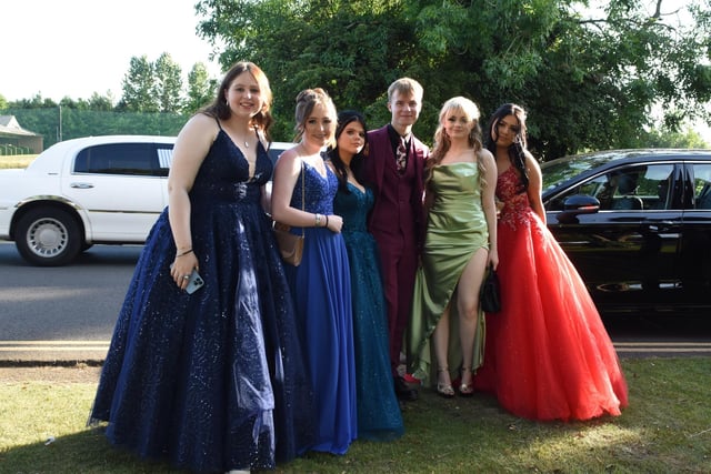 Year 11 students in a colourful array of prom dresses and suit.