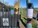 Poo bah holders have been placed on fences in the area