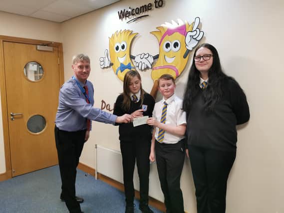 Friends Yvie, Oliver and Annie presenting the cheque to Daft as a Brush Cancer Patient Care