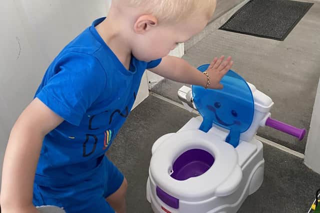 Elijah playing with the potty