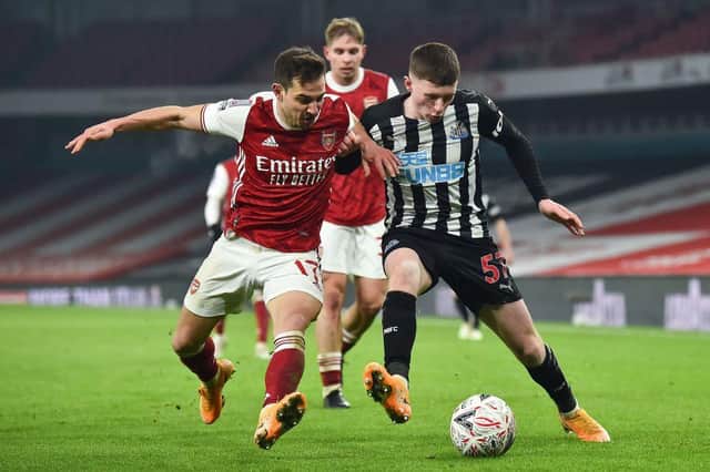 Arsenal's German-born Portuguese defender Cedric Soares (L) vies with Newcastle United's English midfielder Elliot Anderson (R) during the English FA Cup third round football match between Arsenal and Newcastle United at the Emirates Stadium in London on January 9, 2021.
