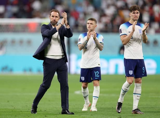 England manager Gareth Southgate alongside Newcastle United's Kieran Trippier and Manchester City defender John Stones (Photo by Richard Heathcote/Getty Images)