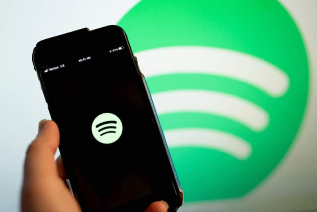 This illustration photo shows the Spotify logo
(Photo by Stefani Reynolds / AFP) (Photo by STEFANI REYNOLDS/AFP via Getty Images)