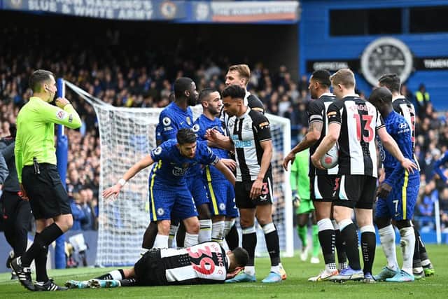 Jorginho of Chelsea and Jacob Murphy of Newcastle United interact as Bruno Guimaraes of Newcastle United is injured during the Premier League match between Chelsea and Newcastle United at Stamford Bridge (Photo by Clive Mason/Getty Images)