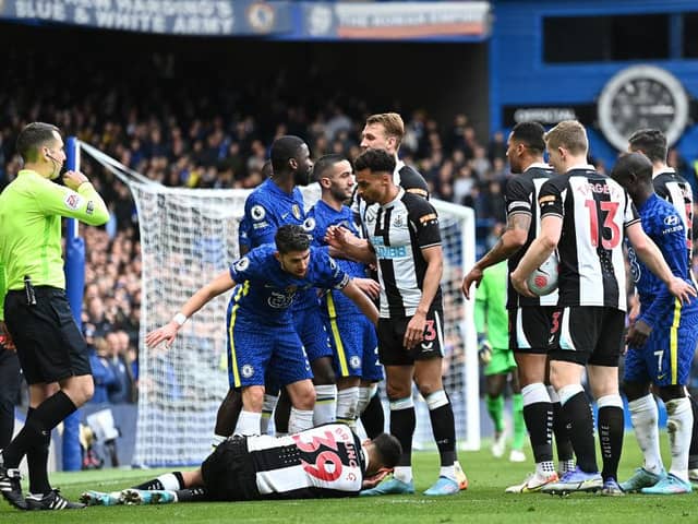 Jorginho of Chelsea and Jacob Murphy of Newcastle United interact as Bruno Guimaraes of Newcastle United is injured during the Premier League match between Chelsea and Newcastle United at Stamford Bridge (Photo by Clive Mason/Getty Images)