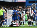 Jorginho of Chelsea and Jacob Murphy of Newcastle United interact as Bruno Guimaraes of Newcastle United is injured during the Premier League match between Chelsea and Newcastle United at Stamford Bridge (Photo by Clive Mason/Getty Images)