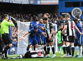 Jorginho of Chelsea and Jacob Murphy of Newcastle United interact as Bruno Guimaraes of Newcastle United is injured during the Premier League match between Chelsea and Newcastle United at Stamford Bridge (Photo by Clive Mason/Getty Images)