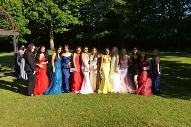 Year 11 girls together in a wide and colourful array of prom dresses.