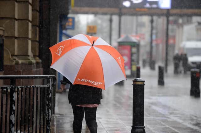Shoppers deal with heavy rain and strong winds on King Street, South Shields. Picture by Stu Norton.