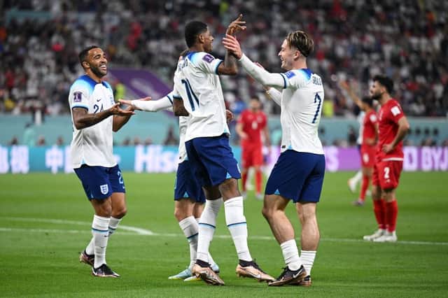 Jack Grealish celebrates with Callum Wilson and Marcus Rashford  after scoring their team's sixth goal during the FIFA World Cup Qatar 2022 Group B match between England and IR Iran at Khalifa International Stadium on November 21, 2022 in Doha, Qatar. (Photo by Matthias Hangst/Getty Images)