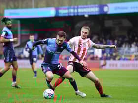 HIGH WYCOMBE, ENGLAND - JANUARY 08: Carl Winchester of Sunderland tackles Josh Scowen of Wycombe Wanderers during the Sky Bet League One match between Wycombe Wanderers and Sunderland at Adams Park on January 08, 2022 in High Wycombe, England. (Photo by Alex Burstow/Getty Images)