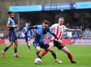 HIGH WYCOMBE, ENGLAND - JANUARY 08: Carl Winchester of Sunderland tackles Josh Scowen of Wycombe Wanderers during the Sky Bet League One match between Wycombe Wanderers and Sunderland at Adams Park on January 08, 2022 in High Wycombe, England. (Photo by Alex Burstow/Getty Images)