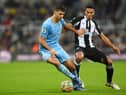 Rodrigo of Manchester City holds off Isaac Hayden of Newcastle United. (Photo by Stu Forster/Getty Images)