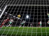 Bournemouth's Argentinian defender Marcos Senesi (L) scores the opening goal past Newcastle United's English goalkeeper Nick Pope during the English Premier League football match between Bournemouth and Newcastle United at the Vitality Stadium in Bournemouth, southern England on February 11, 2023.  (Photo by GLYN KIRK/AFP via Getty Images)