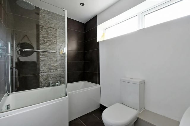 The brochure says: "The stunning bathroom is beautifully tiled with an attractive white suite."