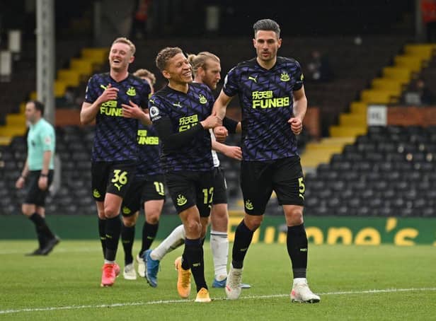 Newcastle United's Swiss defender Fabian Schar (C) celebrates scoring a goal from the penalty spot during the English Premier League football match between Fulham and Newcastle United at Craven Cottage in London on May 23, 2021.