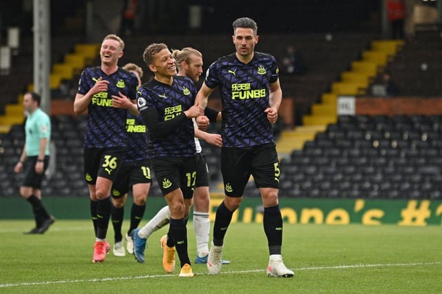 Newcastle United's Swiss defender Fabian Schar (C) celebrates scoring a goal from the penalty spot during the English Premier League football match between Fulham and Newcastle United at Craven Cottage in London on May 23, 2021.