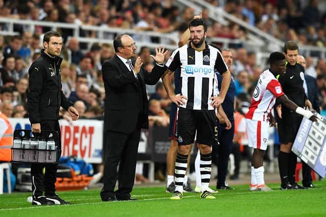 Rafa Benitez speaks to Grant Hanley during a cup game.