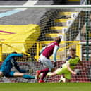 Matej Vydra of Burnley scores their team's first goal past Martin Dubravka and Matt Ritchie of Newcastle United during the Premier League match between Burnley and Newcastle United at Turf Moor on April 11, 2021 in Burnley, England.