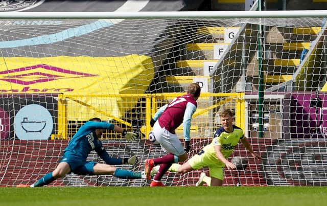 Matej Vydra of Burnley scores their team's first goal past Martin Dubravka and Matt Ritchie of Newcastle United during the Premier League match between Burnley and Newcastle United at Turf Moor on April 11, 2021 in Burnley, England.