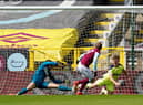 Matej Vydra of Burnley scores their team's first goal past Martin Dubravka and Matt Ritchie of Newcastle United during the Premier League match between Burnley and Newcastle United at Turf Moor on April 11, 2021 in Burnley, England.