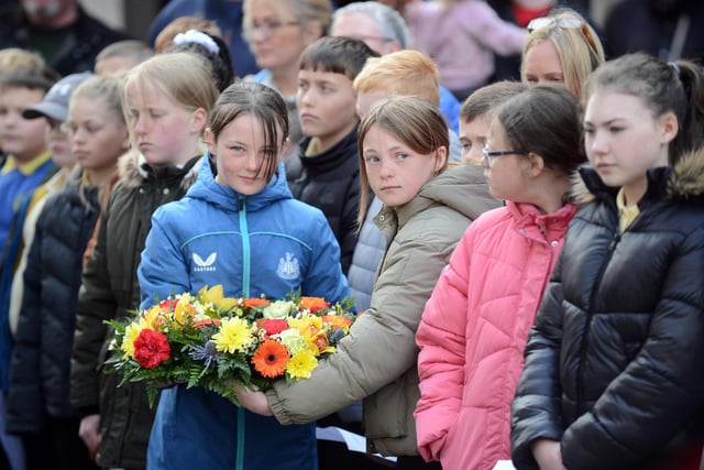 Local school children attend the Anzac Day service at the John Simpson Kirkpatrick memorial statue.