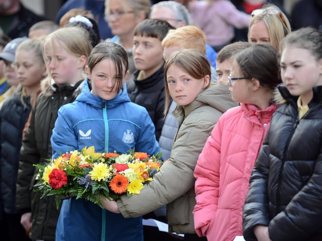 Local school children attend the Anzac Day service at the John Simpson Kirkpatrick memorial statue.