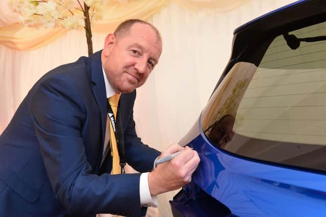 Tony Park signs the Qashqai tailgate