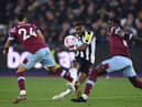 Allan Saint-Maximin of Newcastle United shoots under pressure from Thilo Kehrer of West Ham United and Kurt Zouma of West Ham United  during the Premier League match between West Ham United and Newcastle United at London Stadium on April 05, 2023 in London, England. (Photo by Justin Setterfield/Getty Images)