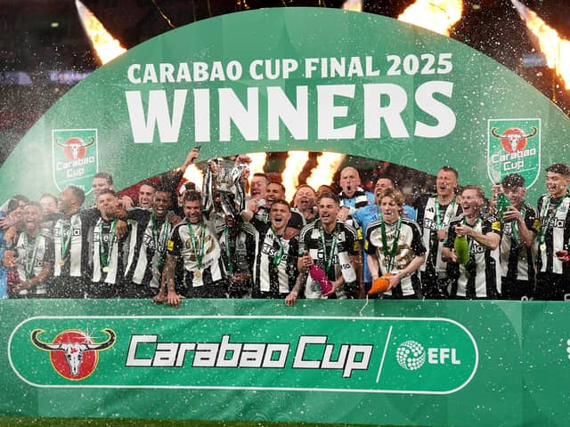 Newcastle United's Bruno Guimaraes and Kieran Trippier lift the Carabao Cup trophy with team-mates following victory at Wembley Stadium over Liverpool. (Photo by Owen Humphreys/PA Wire)