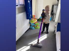 Elijah enjoying the vacuuming.
