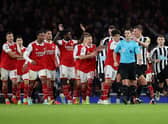 Arsenal players surround the Referee Andy Madley after a late penalty appeal during the Premier League match between Arsenal FC and Newcastle United at Emirates Stadium on January 03, 2023 in London, England. (Photo by Julian Finney/Getty Images)
