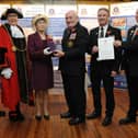 The Lord Lieutenant of Tyne and Wear Mrs Susan Winfield OBE presents the Queen’s Award for Voluntary Service to Tom Fennelly, Honorary Secretary, who received it on behalf of South Shields Volunteer Life Brigade while Senior Brigade Captain Mark Taylor (second right) and Captain Dave Ratcliffe display the official document of conferment of the Award signed by Her Majesty The Queen. Also pictured are Brigade Honorary Treasurer Martin Robertson and the Mayor of South Tyneside Councillor Mrs Pat Hay who officially welcomed the Lord Lieutenant to the ceremony at the Watch House.