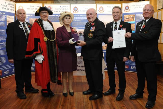 The Lord Lieutenant of Tyne and Wear Mrs Susan Winfield OBE presents the Queen’s Award for Voluntary Service to Tom Fennelly, Honorary Secretary, who received it on behalf of South Shields Volunteer Life Brigade while Senior Brigade Captain Mark Taylor (second right) and Captain Dave Ratcliffe display the official document of conferment of the Award signed by Her Majesty The Queen. Also pictured are Brigade Honorary Treasurer Martin Robertson and the Mayor of South Tyneside Councillor Mrs Pat Hay who officially welcomed the Lord Lieutenant to the ceremony at the Watch House.